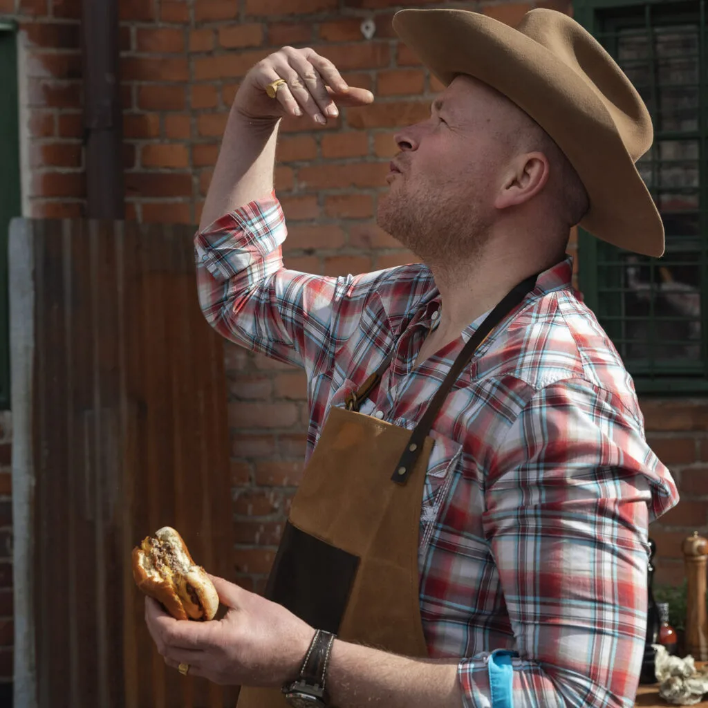 Grill master savoring a freshly made burger