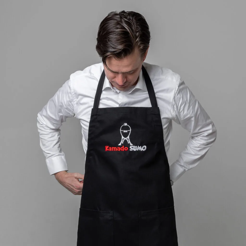 Person wearing a black Kamado Sumo apron