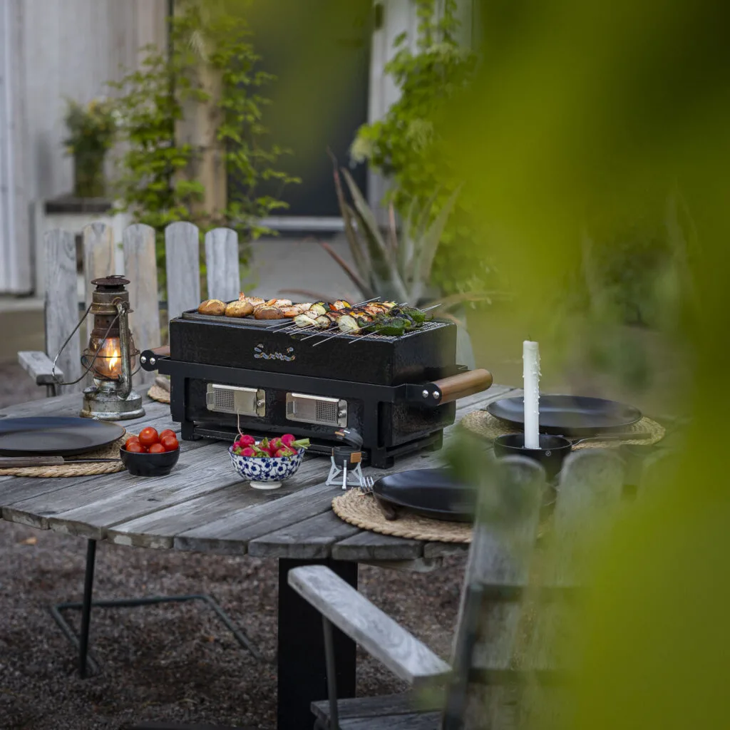 Kamado Sumo ceramic grill on a rustic outdoor table