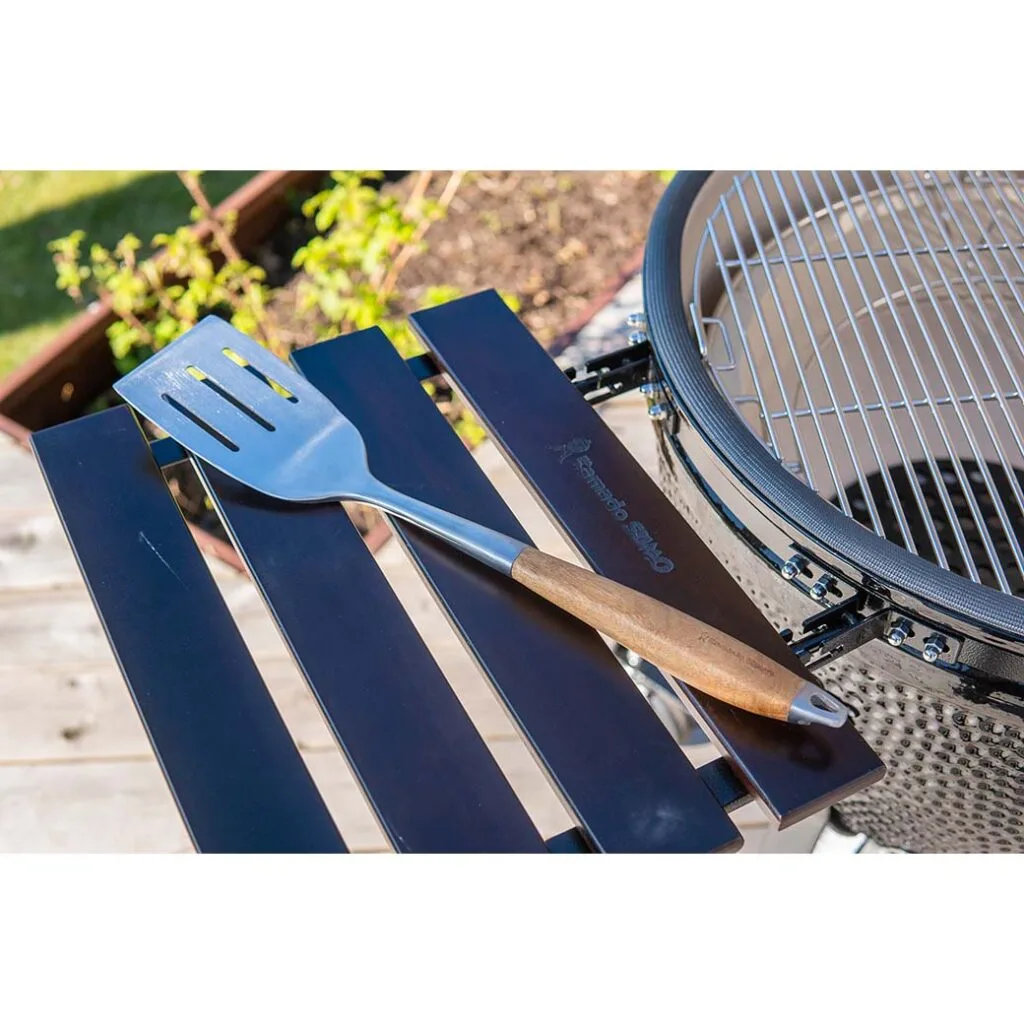 Stainless steel spatula on a Kamado Sumo grill shelf