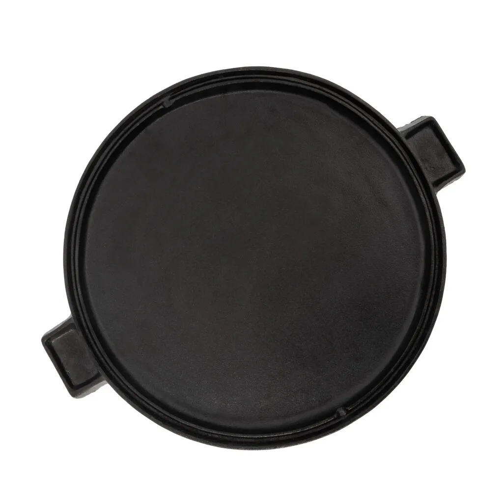 Reversible cast iron cooking plate for grilling and baking