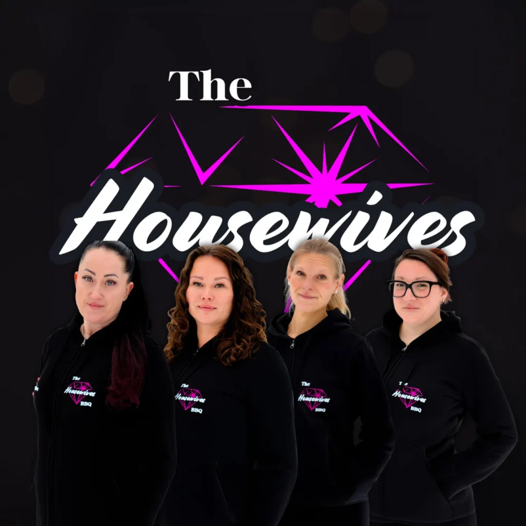 Four women in matching black hoodies with The Housewives BBQ logo