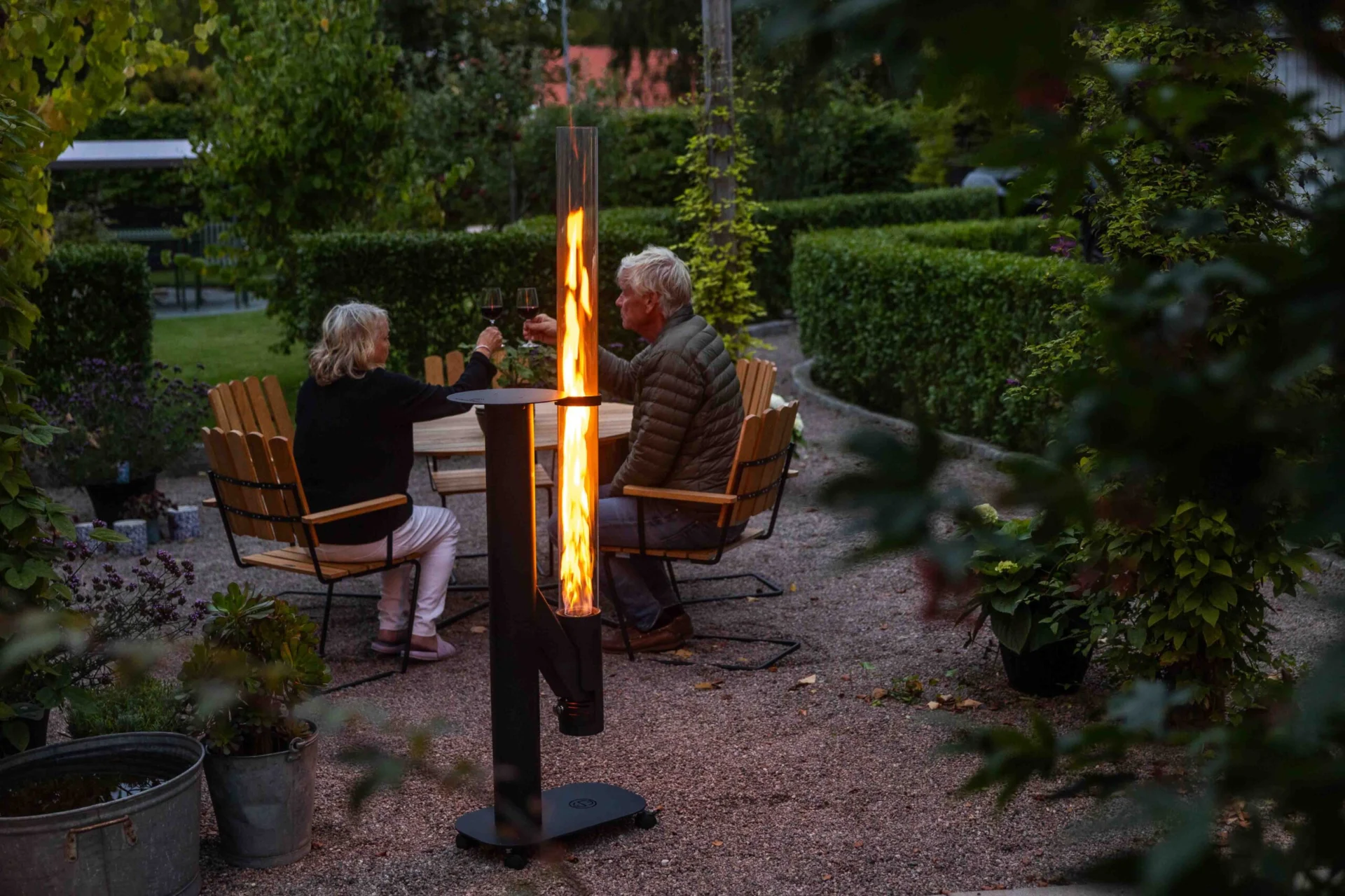 Kamado Sumo Flame Tower glowing in an outdoor evening setting